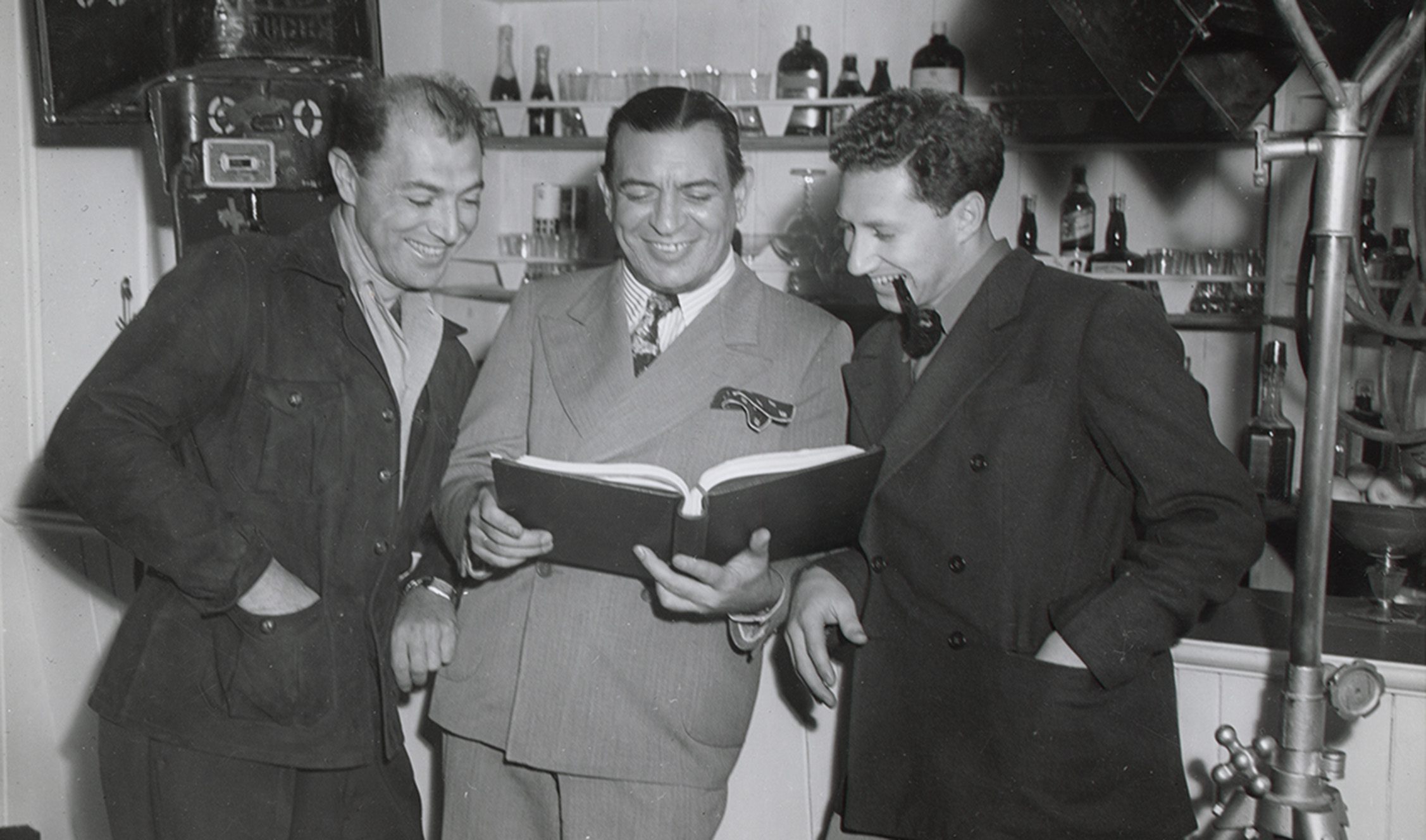 Three men looking at book