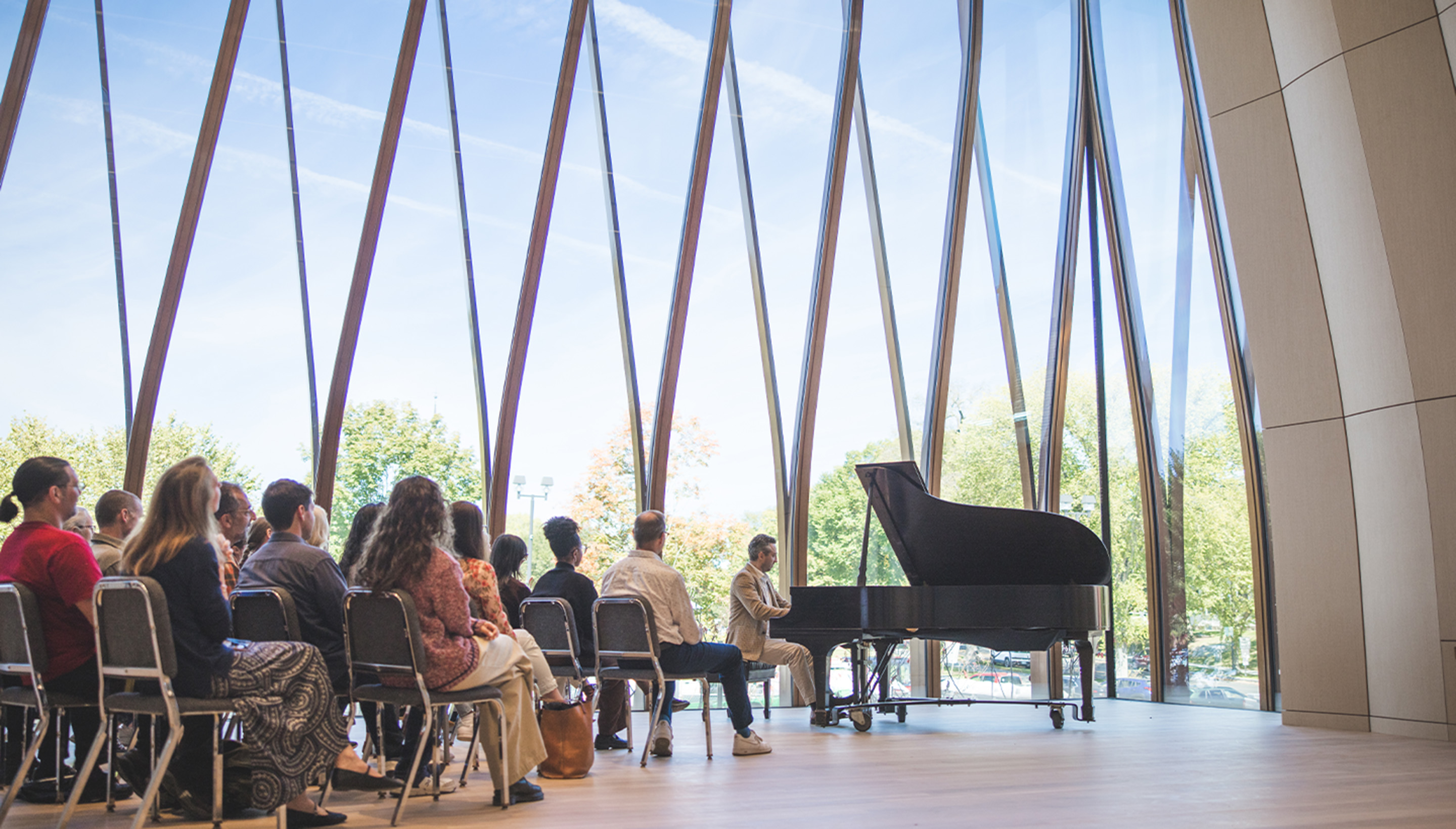 Man playing piano in front of audience.