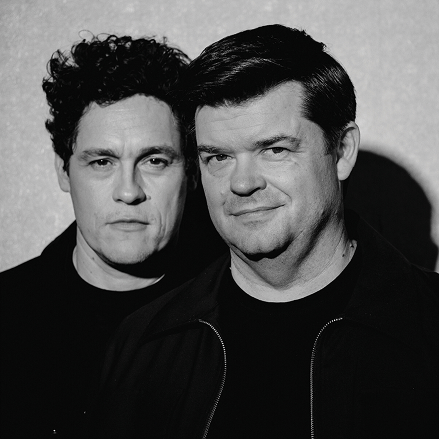 Two men posing for camera