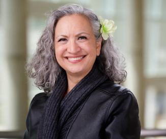 Headshot of woman with flower in her hair