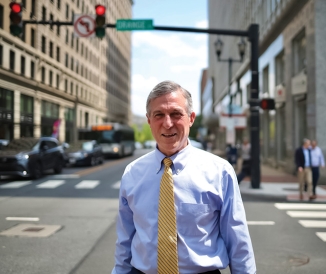 Man in business attire standing in city street