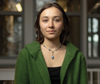 Headshot of woman wearing green sweater