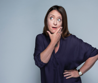 Woman posing with hands on chin and hip