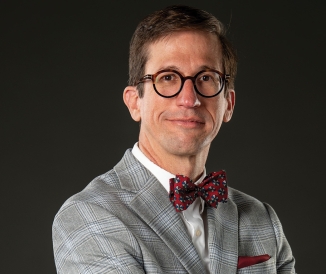 Man wearing glasses and bowtie