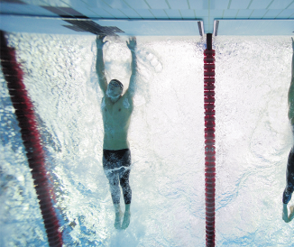 Two men tapping wall in swim race