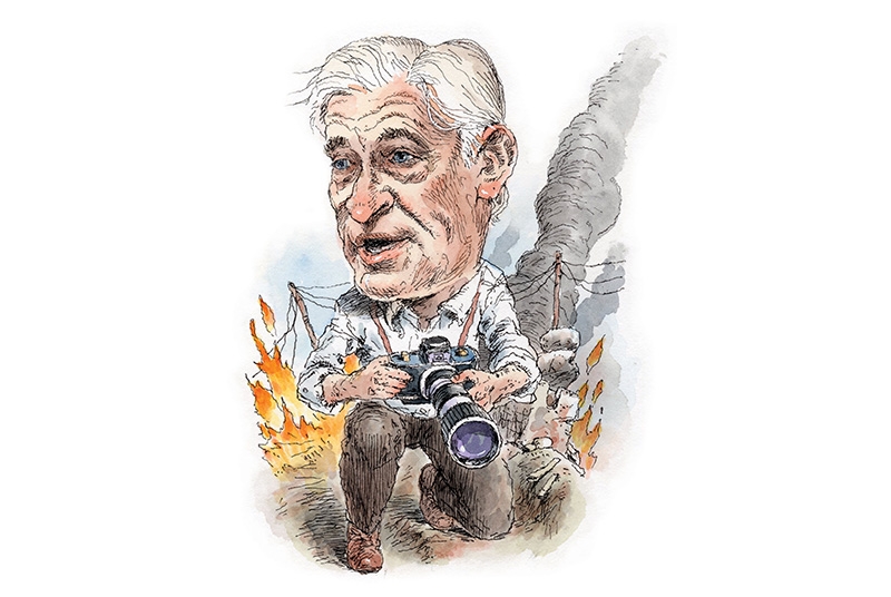 Illustration of man holding a camera, kneeling on ground with snow and flames in background