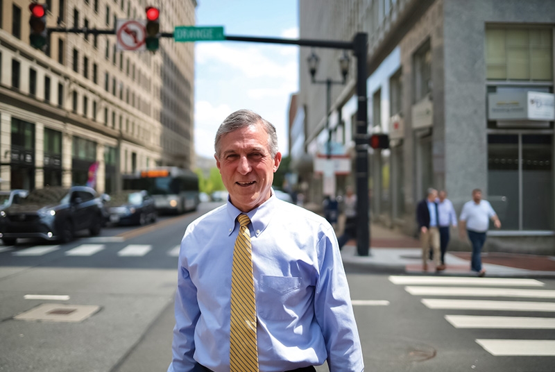 Man in business attire standing in city street