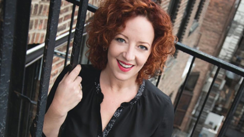 Headshot of woman posing on fire escape in city