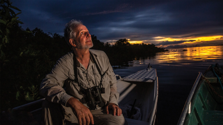 Man in canoe looking at sky