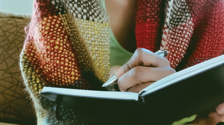 Person writing in journal