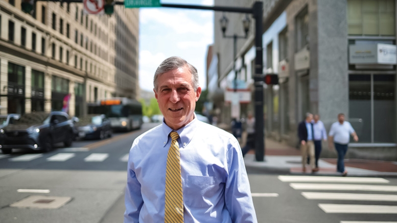 Man in business attire standing in city street