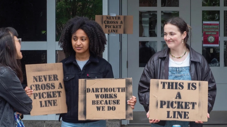 Students holding protest signs