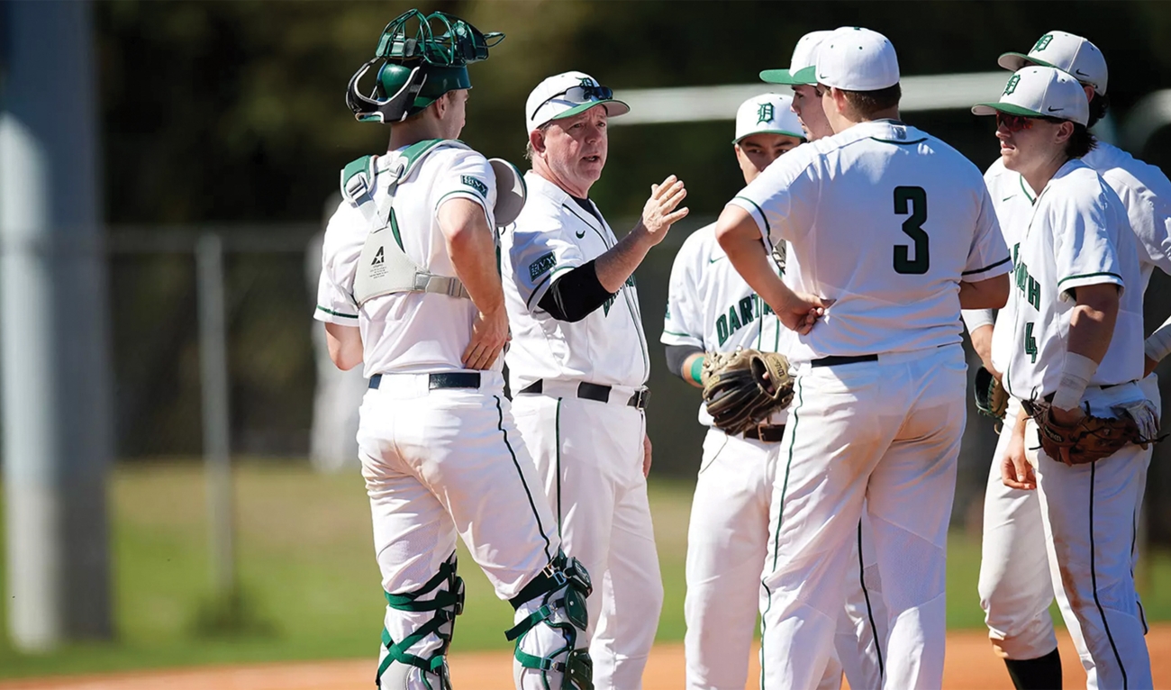 Baseball coach talking to team