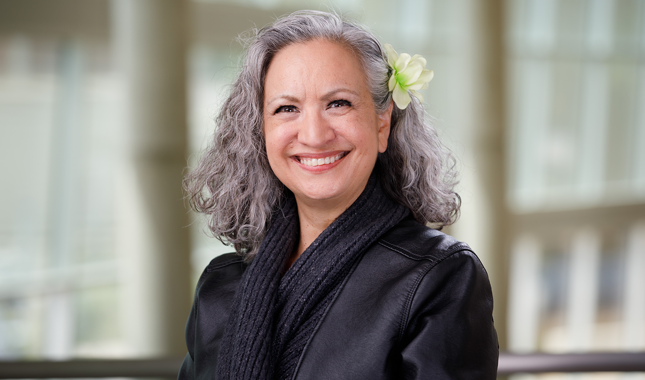 Headshot of woman with flower in her hair