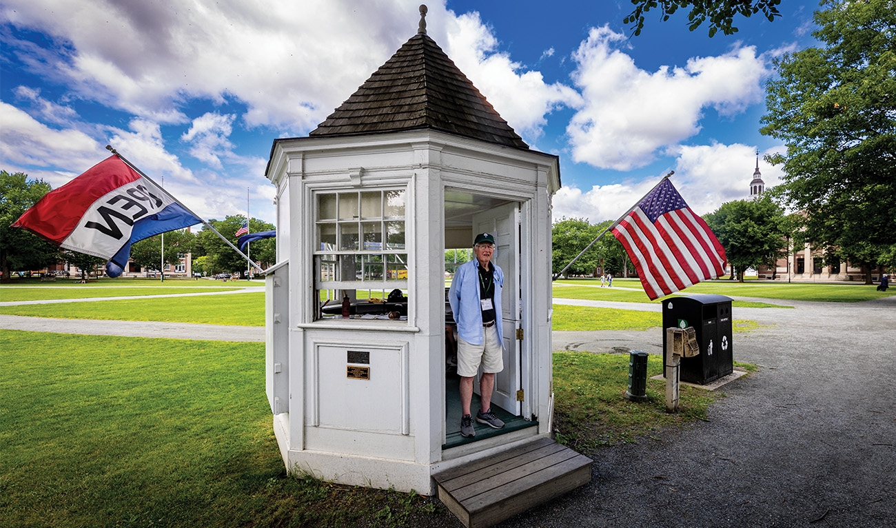 Man standing inside info booth on campus