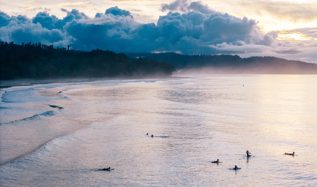 Children surfing in ocean