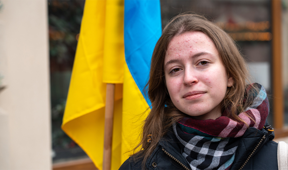 Woman in front of Ukraine flag