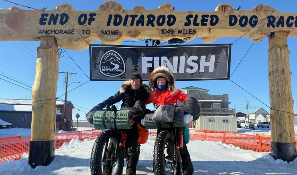 Two people at finish line with bikes