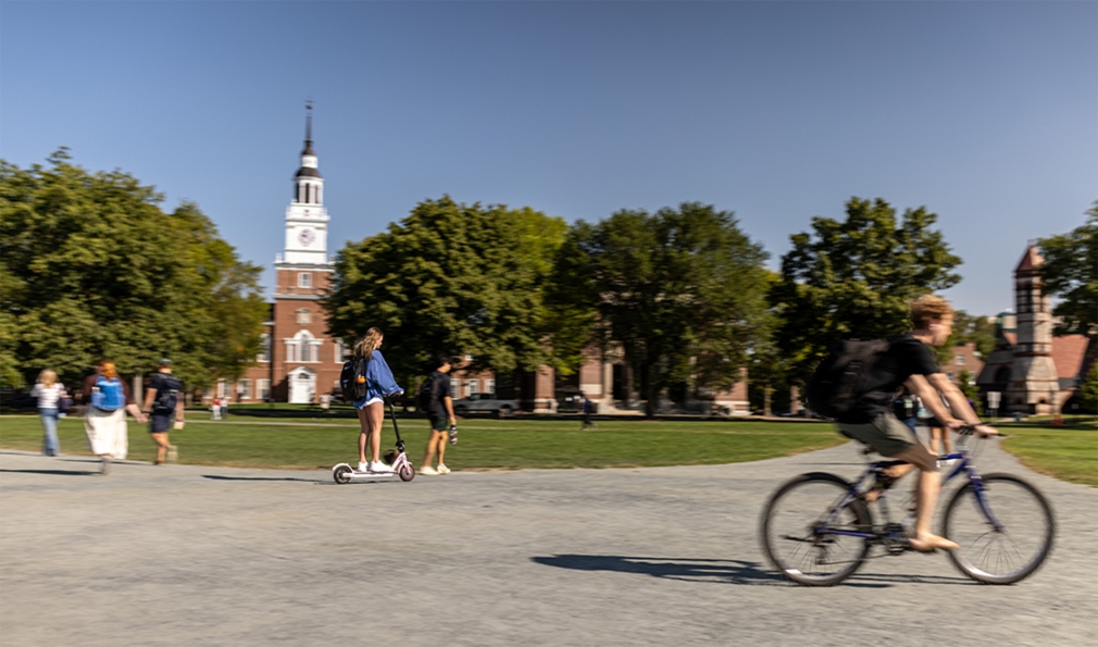 Woman on e-scooter and man on bike