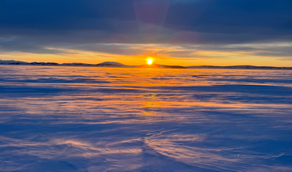 Sun over mountains and snow
