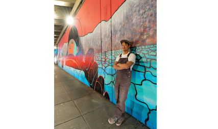 Man standing in front of mural