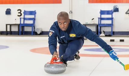 Man sliding stone during curling