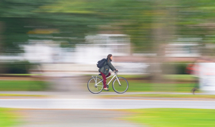 Person riding bike on campus