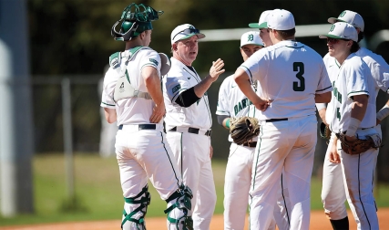 Baseball coach talking to team