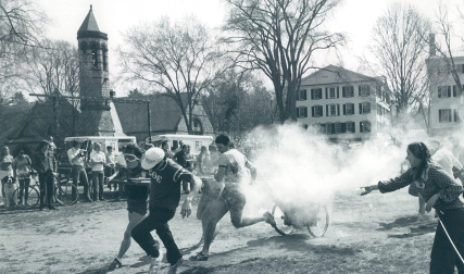 Students throwing food and hauling a chariot
