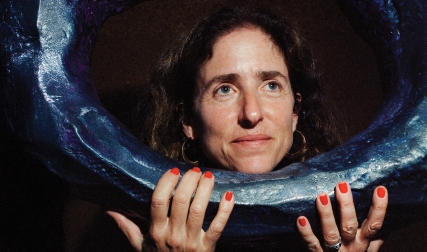 Woman posing with art sculpture
