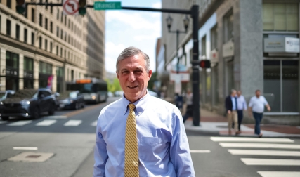 Man in business attire standing in city street