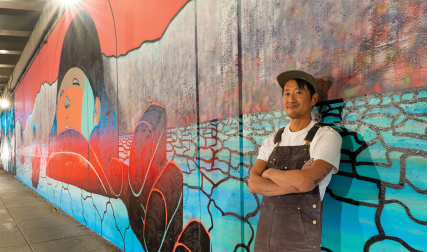 Man standing in front of mural