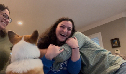 Daughter hugging parents with dog