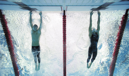 Two men tapping wall in swim race