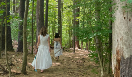 Two women walking in woods
