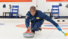 Man sliding stone during curling