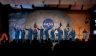 NASA astronaut candidates in jumpsuits waving