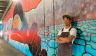 Man standing in front of mural