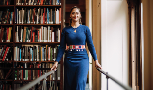Woman posing in front of bookshelf